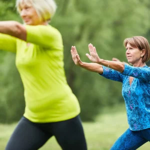 Adults practice Tai Chi.